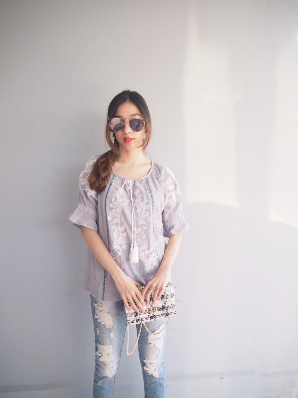 เสื้อทรงปล่อยทิ้งตัวผ้าดี ลายเสื้อปักดอกไม้อย่างดี สีเทา ช่วงตัวเป็นรูระบายทางยาวลงมา แขนพองจั้มแล้วระบายออก เพิ่มความสวยงามด้วยการปักลายดอกไม้เช่นกัน ผูกด้วยเชือกพู่ตรงคอ รวมๆใส่แล้วน่ารักมาก